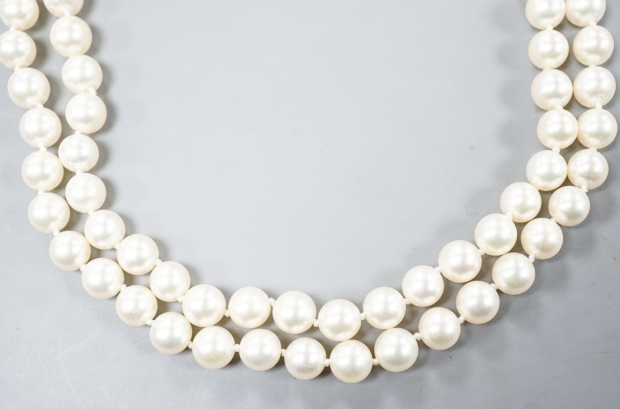 A modern single strand cultured pearl necklace, with diamond chip set spherical clasp, 72cm.